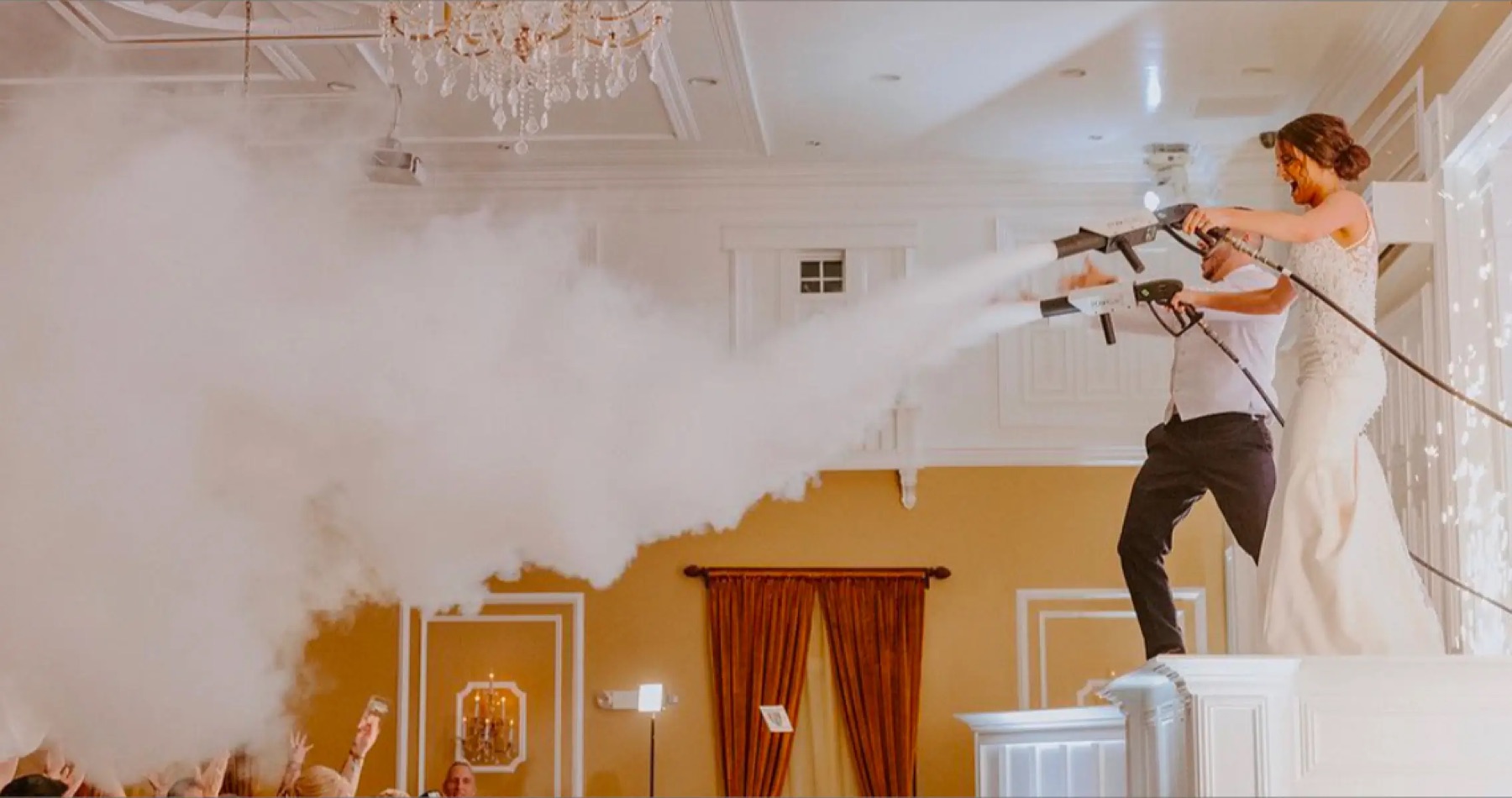 A couple firing CO2 cannons over the dance floor