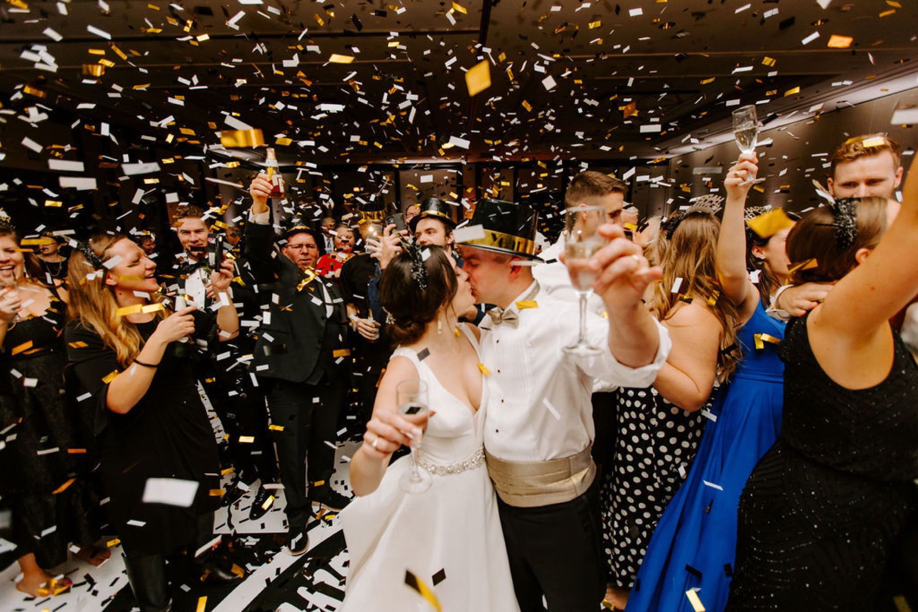 Confetti falling over newlyweds and their guests